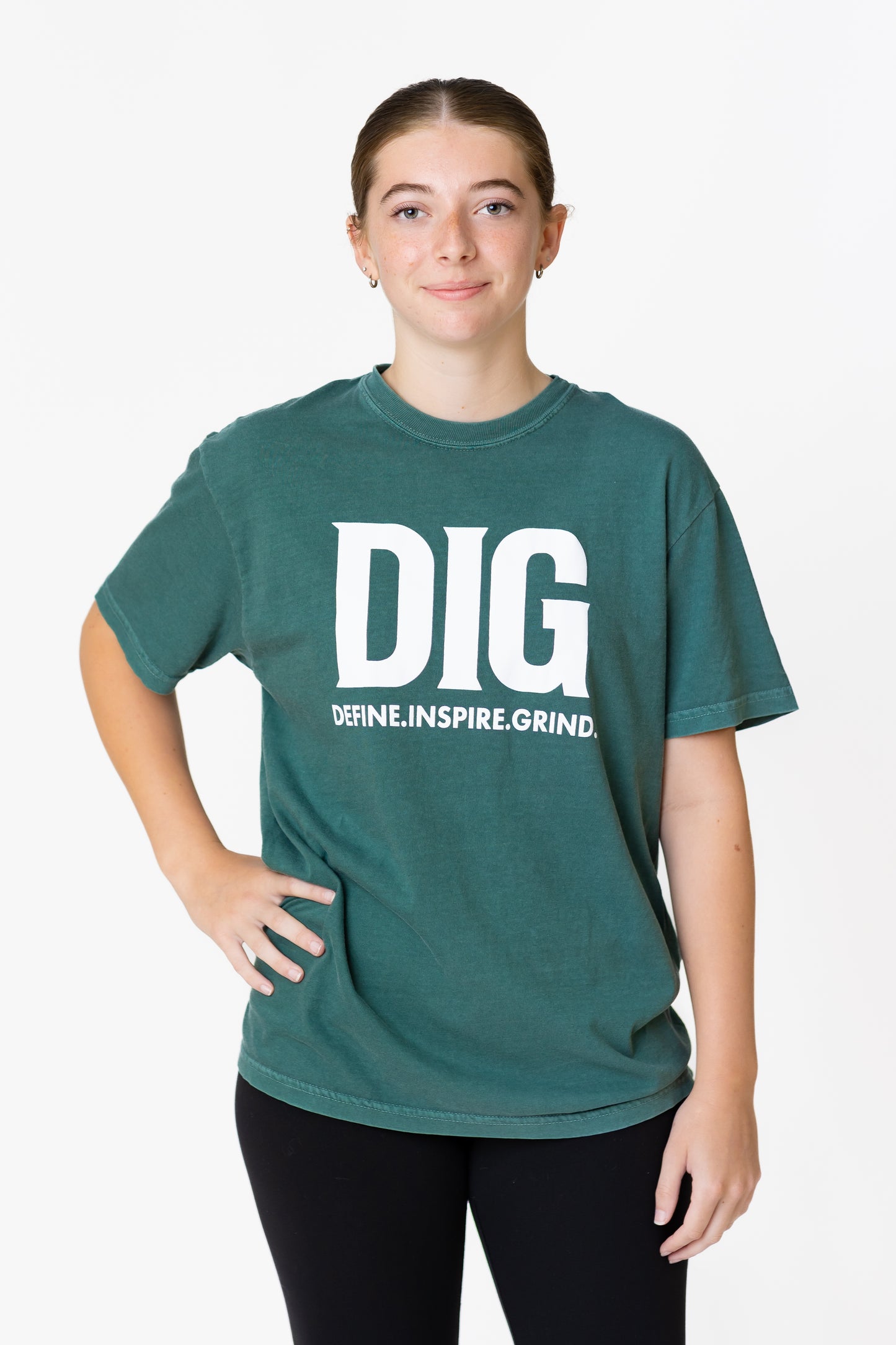 Person wearing a green t-shirt with 'DIG' text on a white background
