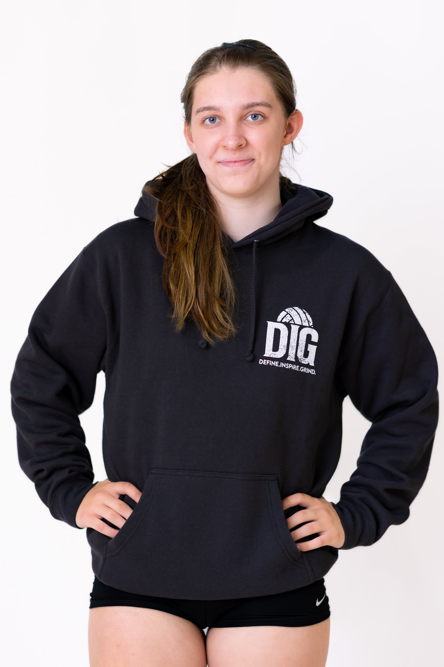 Person wearing a black hoodie with 'DIG' logo on a white background